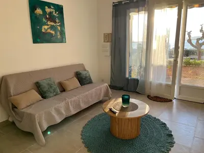 a living room with a couch and a coffee table at Bel appartement pied dans l'eau PROPRIANO in Propriano
