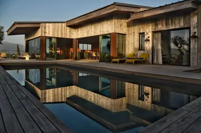 a house with a pool in front of it at Lenza Barn Villa by Boutique Scenic Corsica in Pianottoli-Caldarello