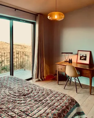 a bedroom with a desk and a bed and a desk and a desk at Lenza Barn Villa by Boutique Scenic Corsica in Pianottoli-Caldarello