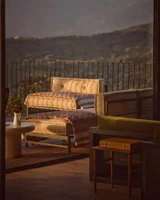 two beds sitting on top of a balcony at Lenza Barn Villa by Boutique Scenic Corsica in Pianottoli-Caldarello