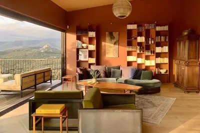 a living room with a couch and a table at Lenza Barn Villa by Boutique Scenic Corsica in Pianottoli-Caldarello