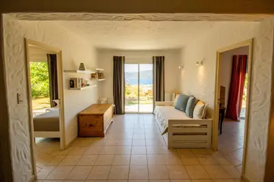 a bedroom with a bed and a view of the ocean at Villa de Charme avec Piscine et vue Mer en Corse du Sud in Propriano