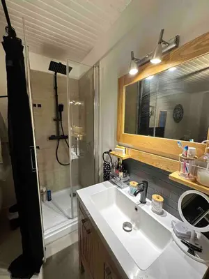 a bedroom with a large black bed in a room at studio au cœur de la vieille ville in Ajaccio
