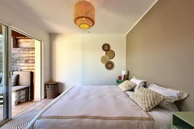 a bedroom with a large bed and a window at Comfortable Villa with Pool Near Cala Rossa & Pinarello Beaches in Porto-Vecchio
