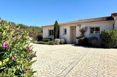 a house with a brick driveway in front of it at Comfortable Villa with Pool Near Cala Rossa & Pinarello Beaches in Porto-Vecchio
