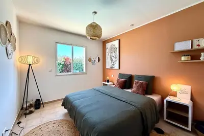 a bedroom with a bed and a window at Comfortable Villa with Pool Near Cala Rossa & Pinarello Beaches in Porto-Vecchio