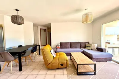 a living room with a couch and a table at Comfortable Villa with Pool Near Cala Rossa & Pinarello Beaches in Porto-Vecchio