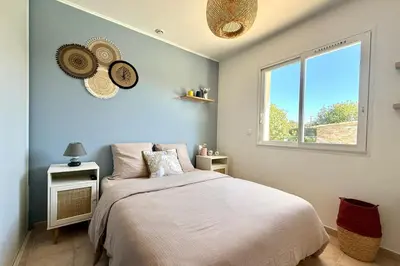 a bedroom with a bed and a window at Comfortable Villa with Pool Near Cala Rossa & Pinarello Beaches in Porto-Vecchio