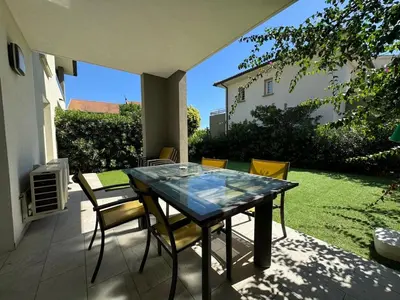 a patio with a glass table and chairs at Moriani-Plage in Santa-Lucia-di-Moriani