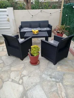a patio with three chairs and a table and a table and chairs at Villa bord de mer Résidence Alba Serena in Poggio-Mezzana