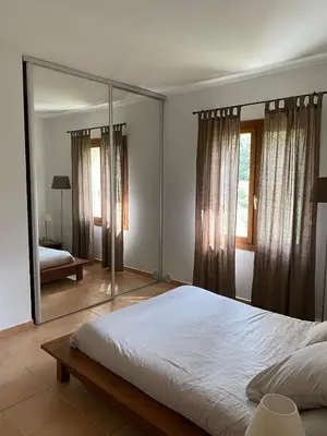 a bedroom with a bed and a large mirror at Sartène à pied in Sartène