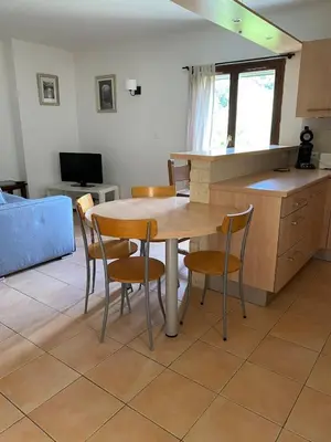 a kitchen and dining room with a table and chairs at Sartène à pied in Sartène