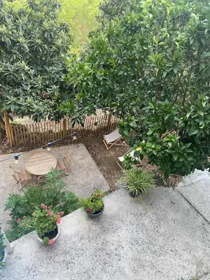 a patio with a table and chairs and plants at Sartène à pied in Sartène