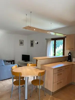 a kitchen and living room with a table and chairs at Sartène à pied in Sartène