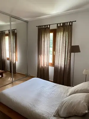 a bedroom with a large bed and a mirror at Sartène à pied in Sartène