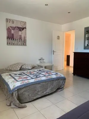 a bedroom with a bed with a quilt on it at Casa pace e salute in Olmeta-di-Tuda