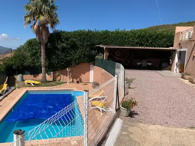 a house with a fence and a swimming pool at Casa pace e salute in Olmeta-di-Tuda