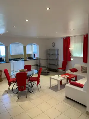 a living room with a table and chairs and a couch at Casa pace e salute in Olmeta-di-Tuda