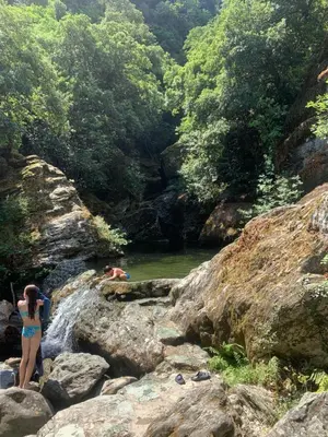 a couple of people standing on rocks in a river at Casa pace e salute in Olmeta-di-Tuda