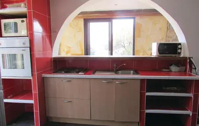 a kitchen with a sink and an arched window at Amazing Apartment In Partinello in Partinello