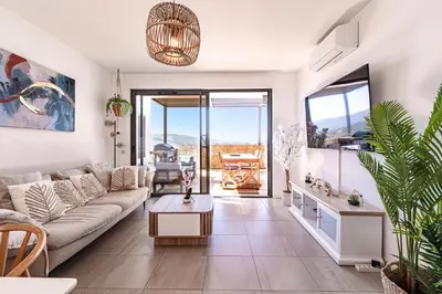 a living room with a couch and a table with chairs at Marylanca - PORTICCIO - double terrasse - Wifi - Clim - Parking Privé in Grosseto-Prugna