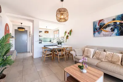 a kitchen with white cabinets and a light fixture at Marylanca - PORTICCIO - double terrasse - Wifi - Clim - Parking Privé in Grosseto-Prugna