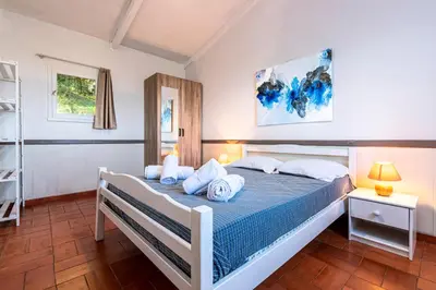 a bedroom with a bed with towels on it at Villa F2 Tonnara pour 4 personnes, Rondinara, Bonifacio in Bonifacio