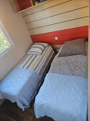 a bedroom with two beds and a window at Logement dans terrain privé et familiale in Bonifacio
