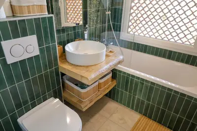 a bathroom with a sink and a toilet and a tub at Casetta Mare di Cala Rossa in Cala Rossa
