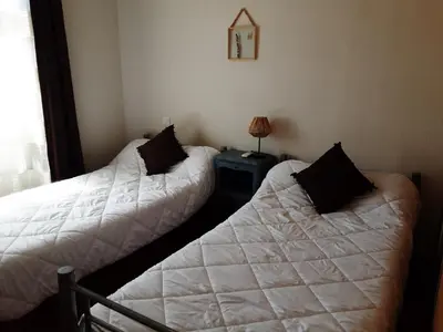 two beds sitting next to each other in a bedroom at La Palombière - L Arbousier in Casalabriva