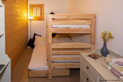 a bedroom with two bunk beds in a room at Oliveraie d'Olmiccia in Olmiccia