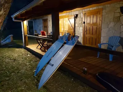 a blue kayak sitting on the porch of a house at Oliveraie d'Olmiccia in Olmiccia