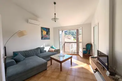 a living room with a couch and a table at Bright apartment with two bedrooms in Ajaccio in Cauro