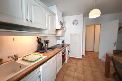 a kitchen with white cabinets and a counter top at Bright apartment with two bedrooms in Ajaccio in Cauro