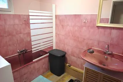 a bathroom with a sink and a trash can at Bright apartment with two bedrooms in Ajaccio in Cauro