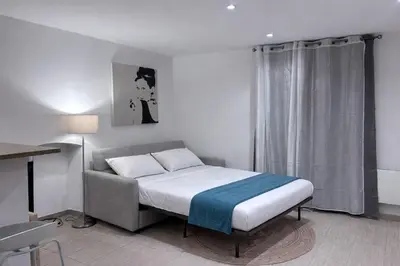 a small bedroom with a bed and a window at Studio vue mer - Centre Ajaccio - 150 m cœur de ville in Ajaccio