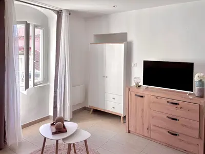 a living room with a television and a dresser at Studio vue mer - Centre Ajaccio - 150 m cœur de ville in Ajaccio