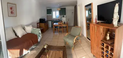a living room with a bed and a television at Mini villa residence 3 étoiles Cervione in Cervione