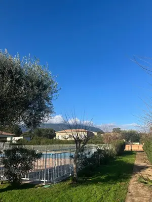 a white fence next to a swimming pool at Mini villa residence 3 étoiles Cervione in Cervione
