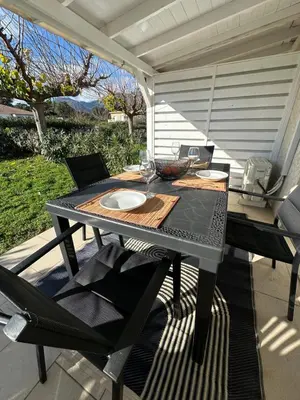 a table and chairs sitting on a patio at Mini villa residence 3 étoiles Cervione in Cervione