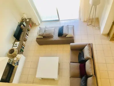 a living room with a couch and a table at Villa de charme et plage 5 mn à pied in Campomoro