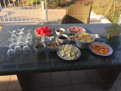 a table with bowls of different types of food on it at Villa de charme et plage 5 mn à pied in Campomoro