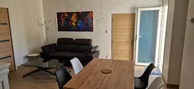 a living room with a table and a couch at Maison a Porto Pollo Corse du sud in Serra-di-Ferro