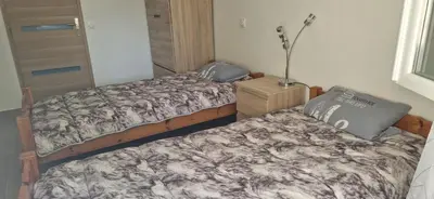 a bedroom with two beds and a lamp on a table at Maison a Porto Pollo Corse du sud in Serra-di-Ferro