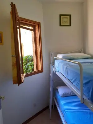 a bedroom with a bunk bed and a window at un oasi nel verde in Vaccili