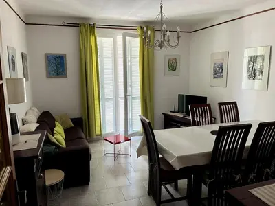 a living room with a table and a couch at Appartement Ajaccio in Ajaccio