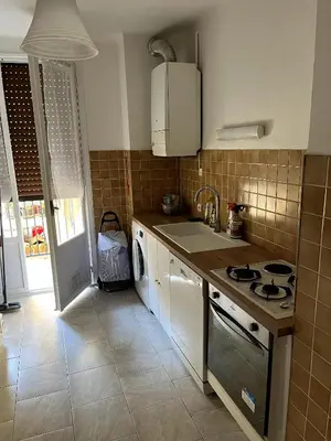 a kitchen with a sink and a stove top oven at Appartement Ajaccio in Ajaccio