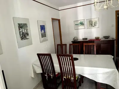 a dining room with a white table and chairs at Appartement Ajaccio in Ajaccio