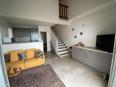 a living room with a yellow couch and a kitchen at Villa Tarco, South Corsica, Sea View & Garden in Conca