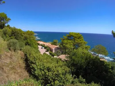 a house on a hill next to the ocean at Villa Tarco, South Corsica, Sea View & Garden in Conca